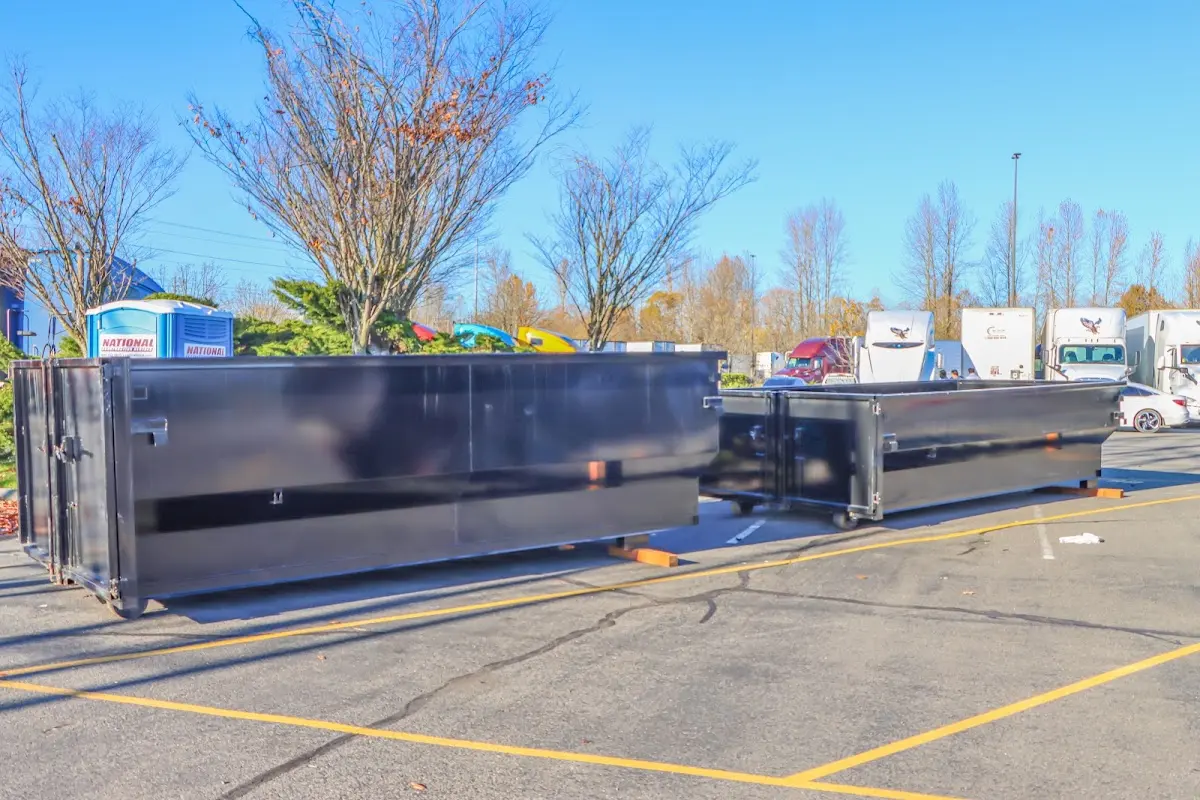 Professional dumpster rental service with roll-off container on residential driveway in Maysville